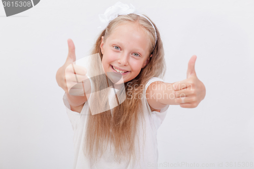 Image of Portrait of a beautiful girl showing thumbs up on white