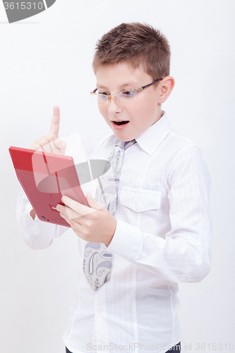 Image of Portrait of teen boy with calculator on white background