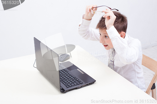 Image of Boy using his laptop computer