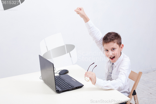 Image of Boy using his laptop computer