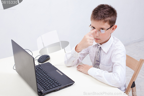 Image of Boy using his laptop computer