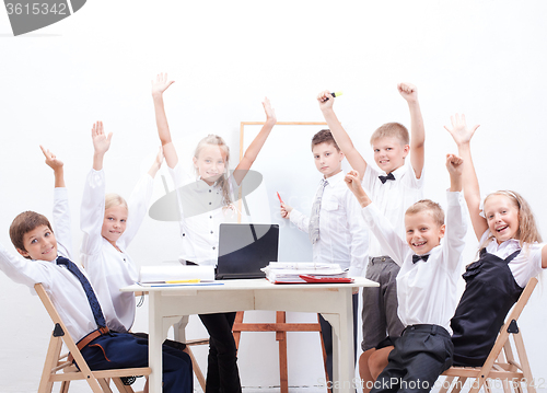 Image of The happy children raising hands 