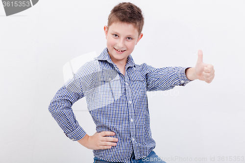 Image of Portrait of happy boy showing thumb up gesture