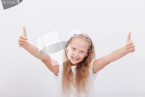 Image of Portrait of a beautiful girl showing thumbs up on white