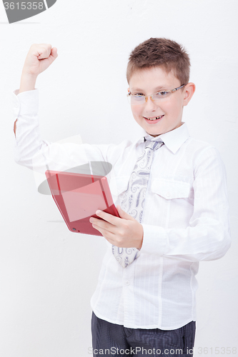 Image of Portrait of teen boy with calculator on white background