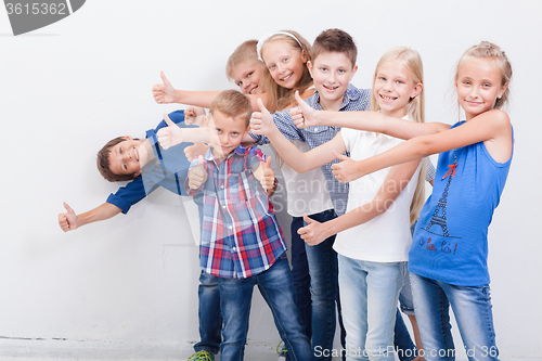Image of The smiling teenagers showing okay sign on white 