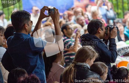 Image of Spectators filming the event