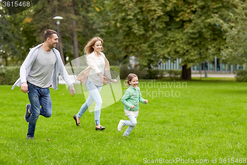 Image of happy family walking in summer park