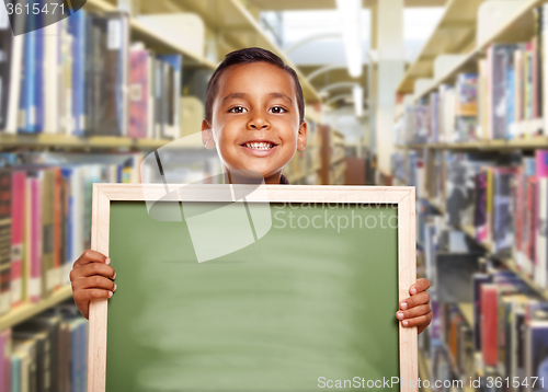 Image of Smiling Hispanic Boy Holding Empty Chalk Board in Library
