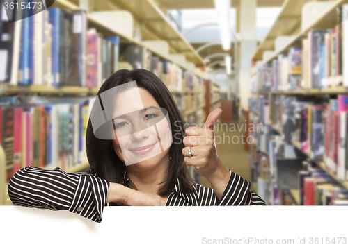 Image of Hispanic Woman with Thumbs Up On White Board in Library