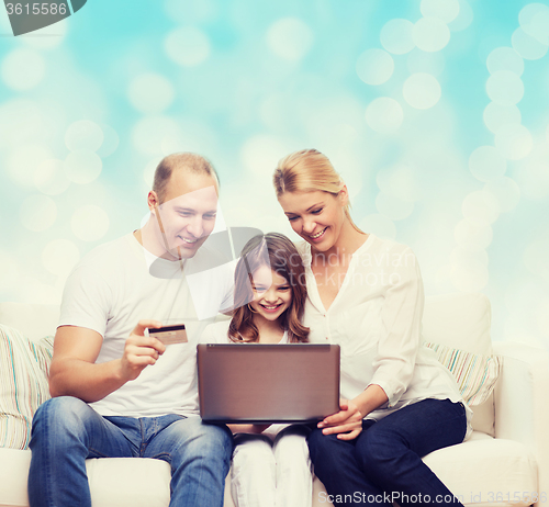 Image of happy family with laptop computer and credit card