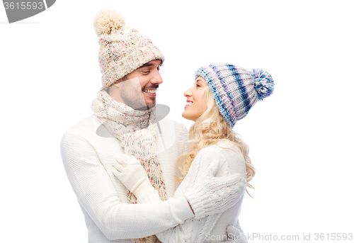 Image of smiling couple in winter clothes hugging