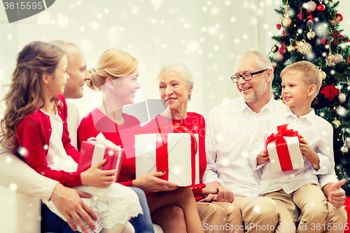 Image of smiling family with gifts at home