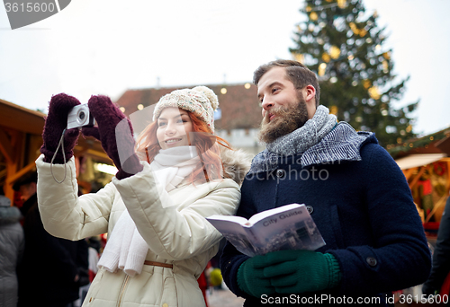 Image of couple taking selfie with smartphone in old town