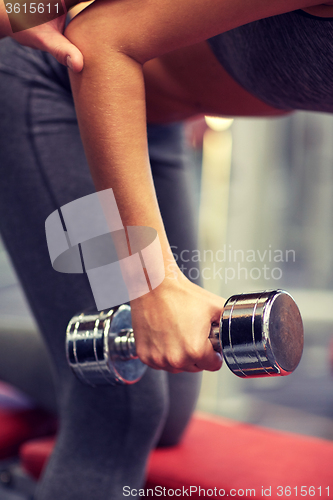 Image of close up of couple with dumbbell exercising in gym