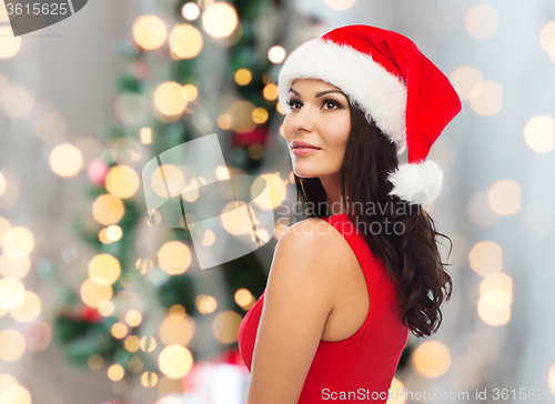 Image of beautiful sexy woman in santa hat and red dress