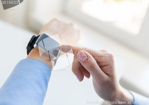 Image of close up of hands setting smart watch