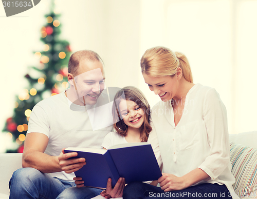 Image of happy family with book at home