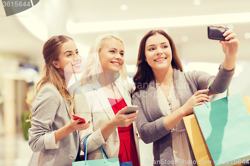 Image of women with smartphones shopping and taking selfie