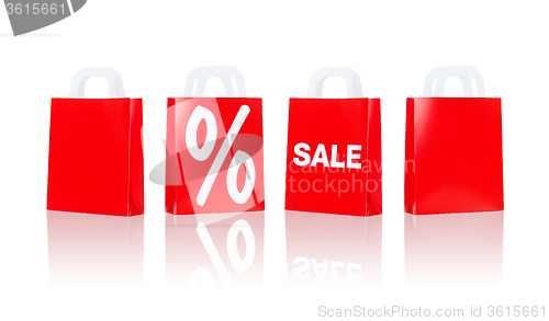 Image of many red shopping bags with sale and percentage