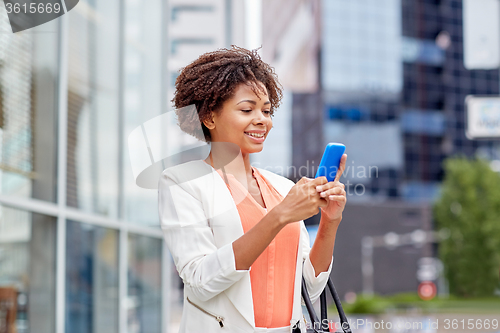 Image of happy african businesswoman with smartphone