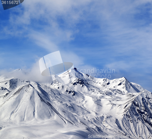 Image of Winter snowy mountains in windy day