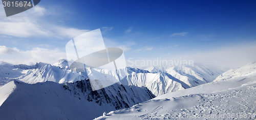 Image of Panoramic view on snowy mountains at sun day