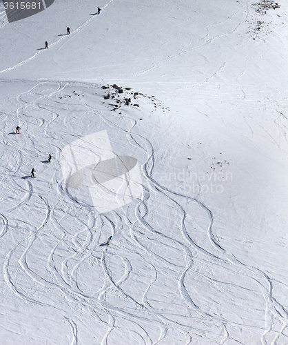 Image of Snowboarder downhill on off piste slope with newly-fallen snow