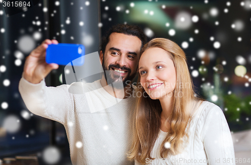 Image of happy couple with smartphone  and coffee at cafe