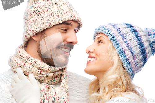 Image of smiling couple in winter clothes hugging