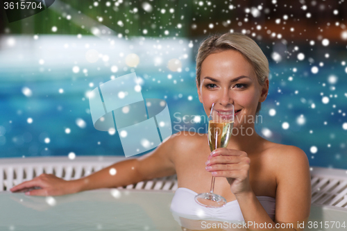 Image of happy woman drinking champagne at swimming pool