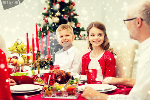 Image of smiling family having holiday dinner at home