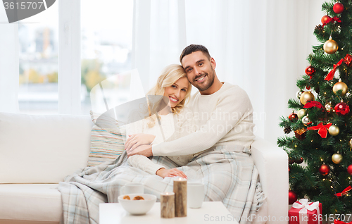 Image of happy couple at home with christmas tree