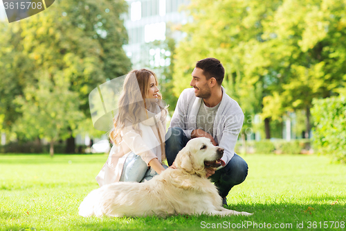 Image of happy couple with labrador dog walking in city