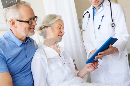 Image of senior woman and doctor with tablet pc at hospital