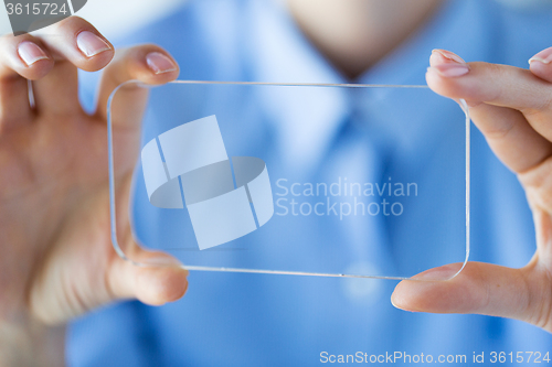 Image of close up of woman with transparent smartphone