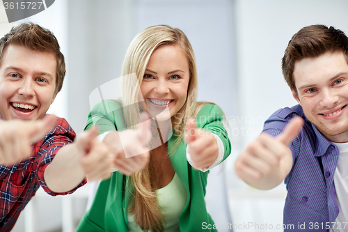 Image of group of happy students showing thumbs up