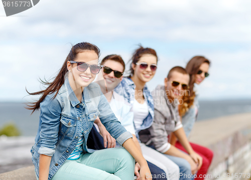 Image of smiling teenage girl hanging out with friends