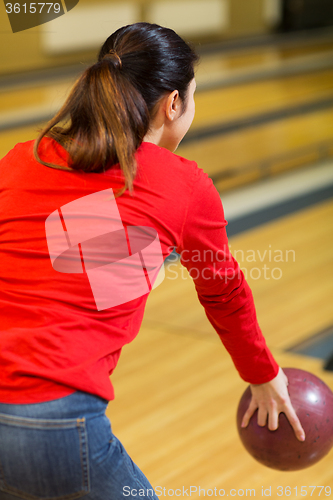 Image of close up of woman throwing ball in bowling club