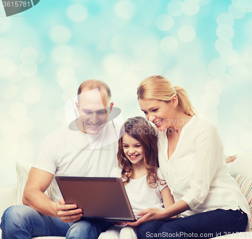 Image of smiling family with laptop