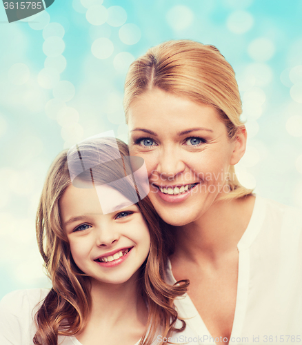 Image of smiling mother and little girl