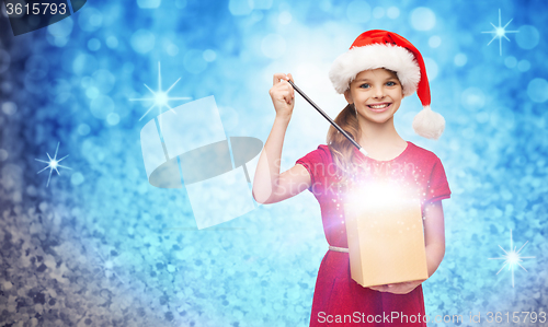 Image of smiling girl in santa helper hat with gift box