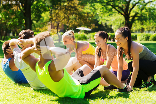 Image of group of friends or sportsmen exercising outdoors