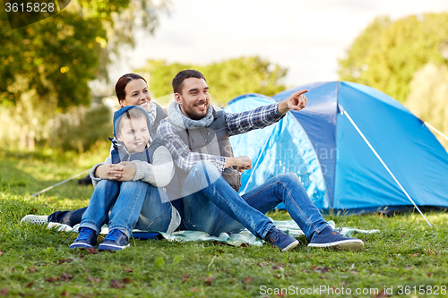 Image of happy family with tent at camp site