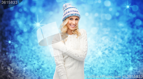 Image of smiling young woman in winter hat and sweater