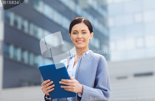 Image of smiling business woman with tablet pc in city