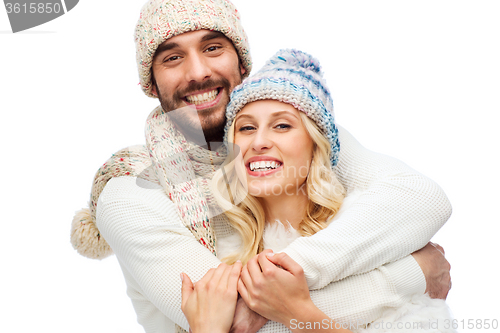 Image of smiling couple in winter clothes hugging