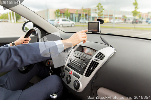 Image of close up of man with gps navigator driving car