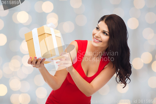 Image of beautiful sexy woman in red dress with gift box