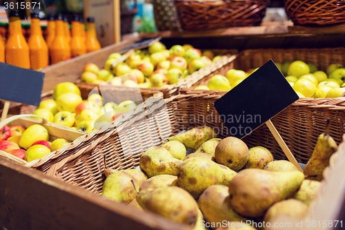 Image of fruits in baskets with nameplates at food market